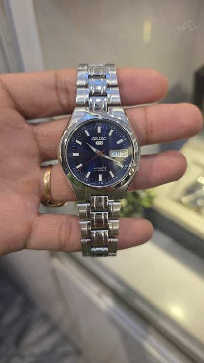 Seiko 5 automatic watch featuring a striking blue dial with an inner 24-hour track and a day-date
